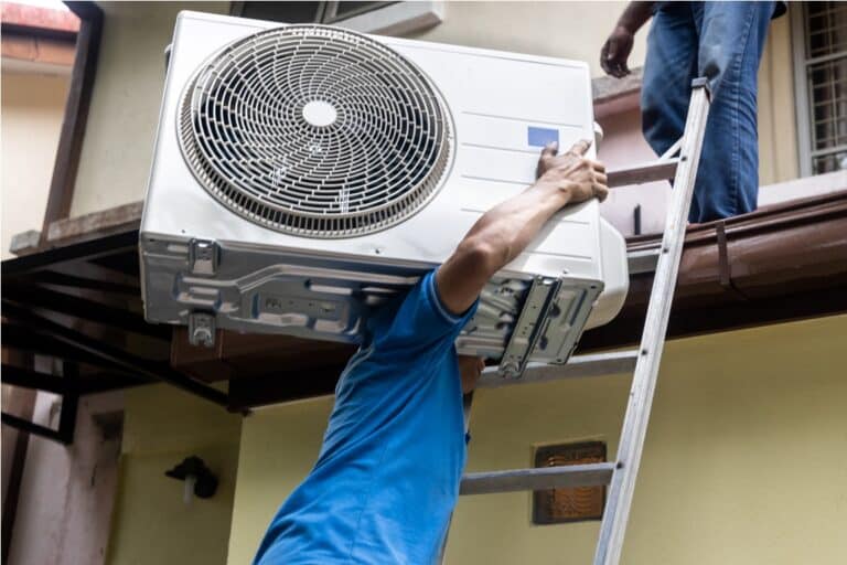 technician transporting outdoor air conditioner co 2022 02 06 21 47 17 utc