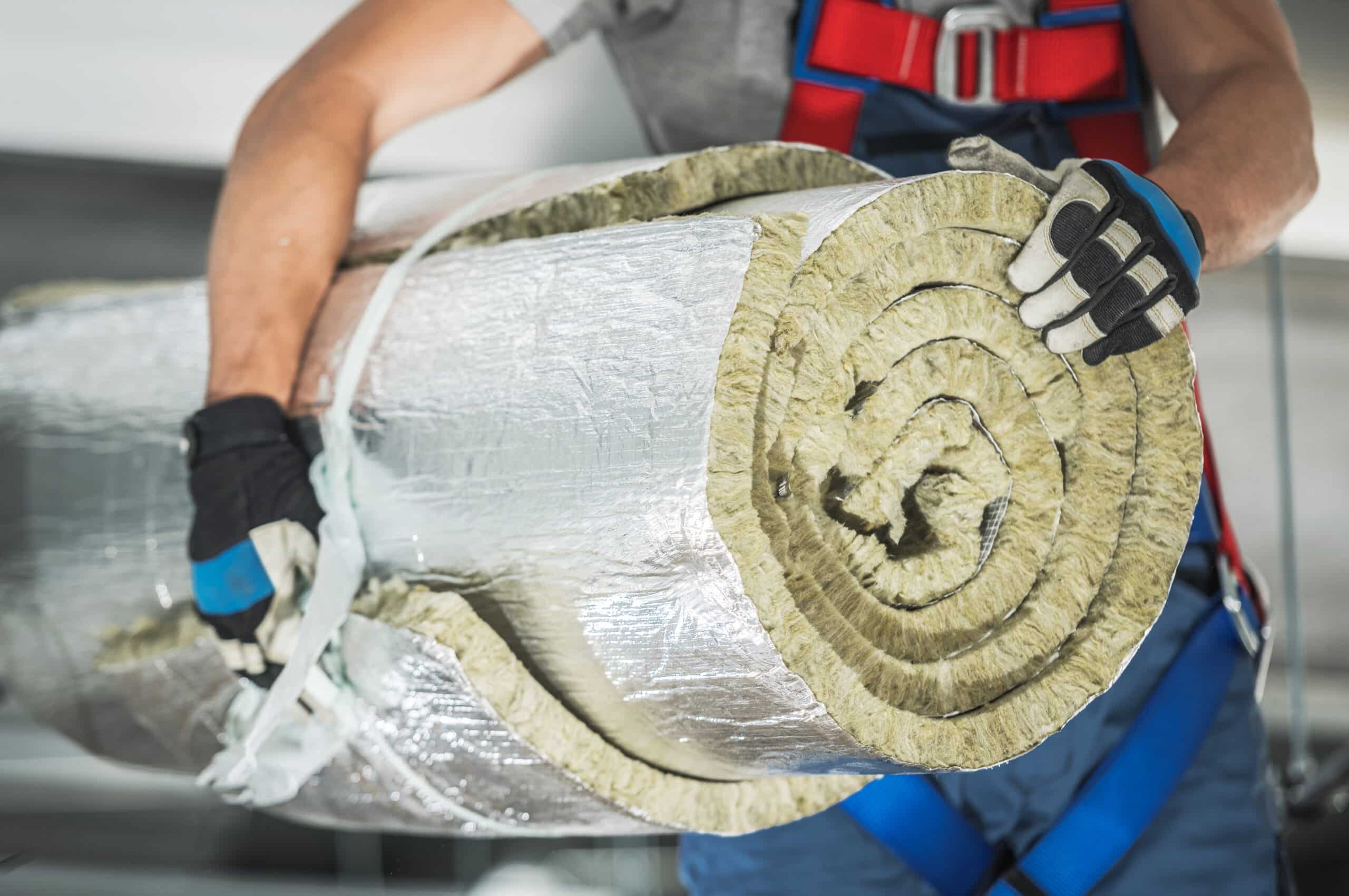 contractor worker with roll of mineral wool insulation