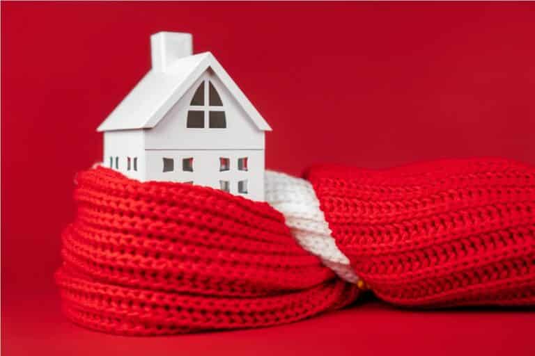 white toy house wrapped in red scarf on red backgr 2022 10 06 04 15 16 utc