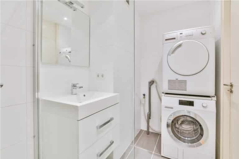 bright bathroom with washing machine and tumble dryer