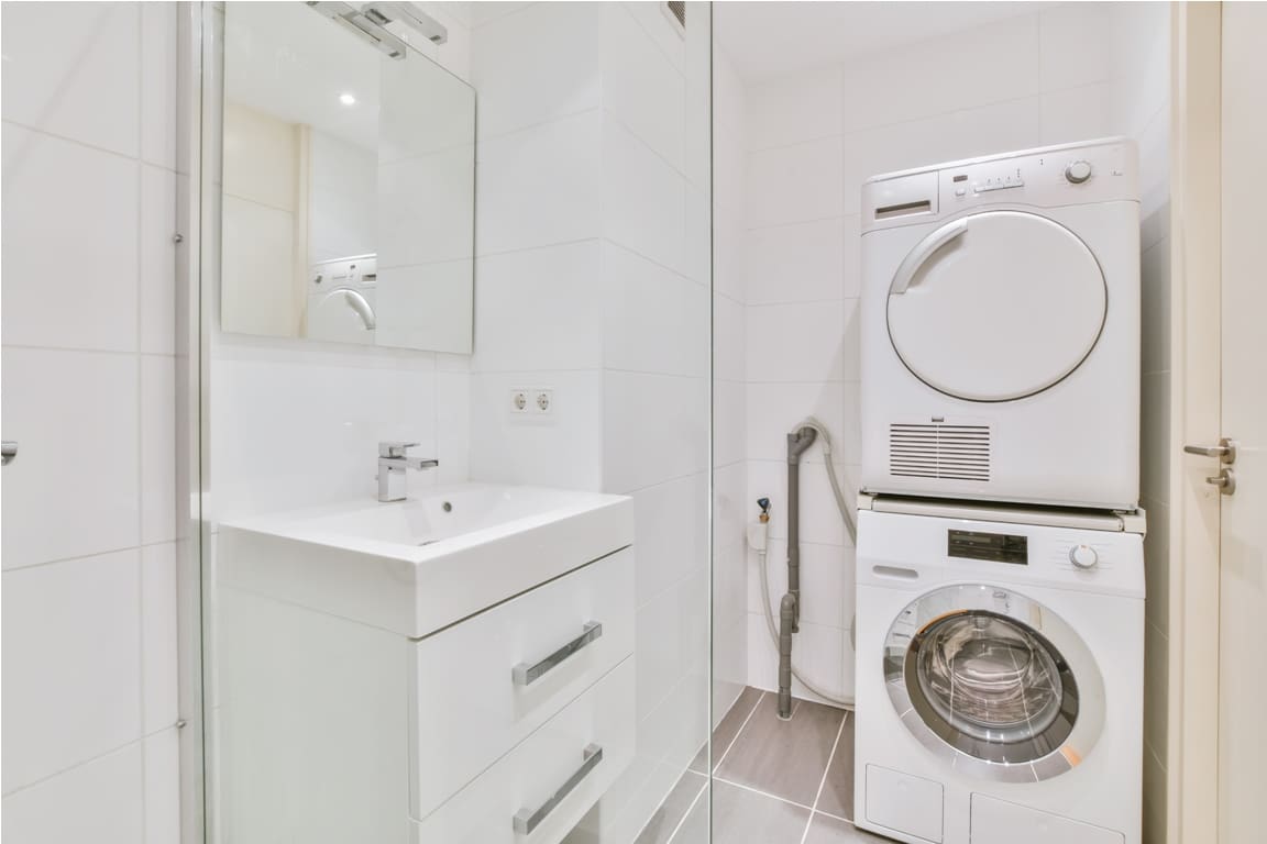bright bathroom with washing machine and tumble dryer