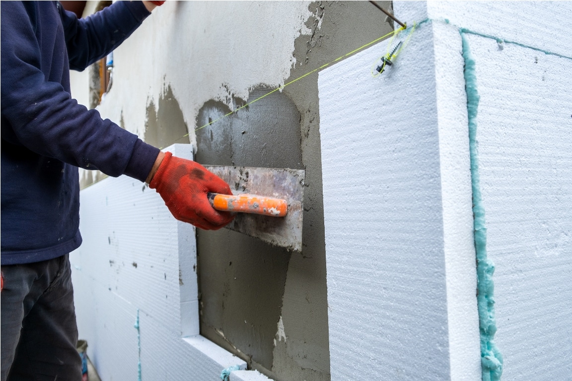 construction worker installing styrofoam insulatio 2022 08 14 08 35 16 utc