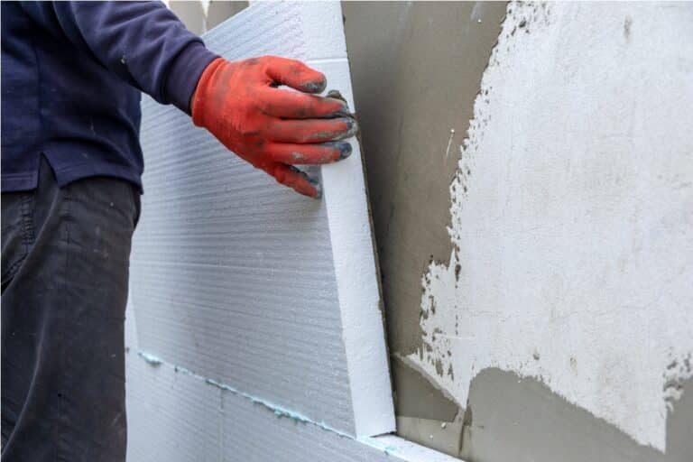 construction worker installing styrofoam insulatio 2022 12 06 00 17 24 utc