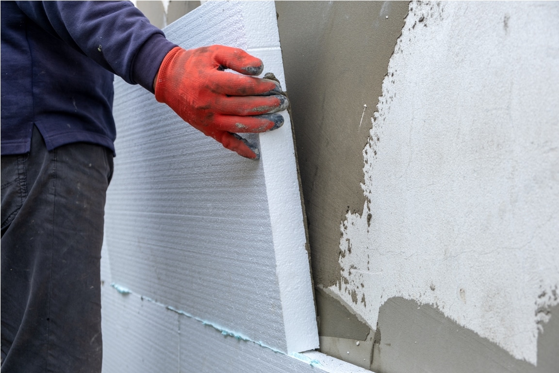 construction worker installing styrofoam insulatio 2022 12 06 00 17 24 utc