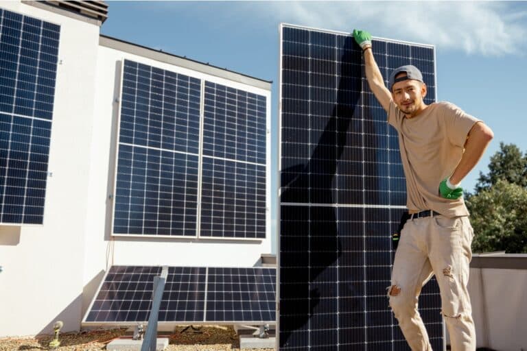 portrait of a man standing with solar panel 2023 11 23 03 42 57 utc