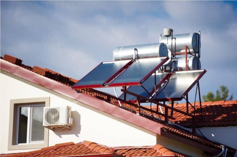 solar heaters on the roof of the house against blue sky.