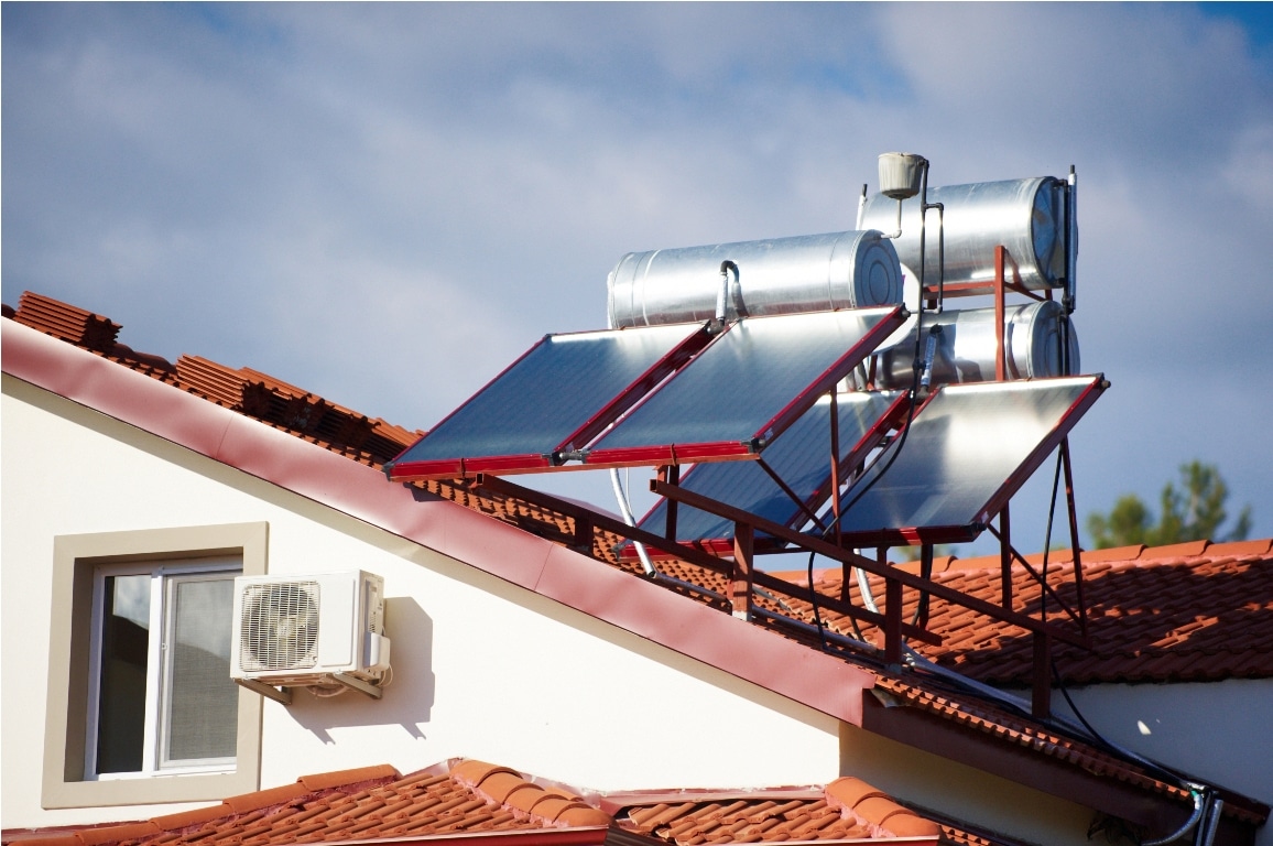 solar heaters on the roof of the house against blue sky.