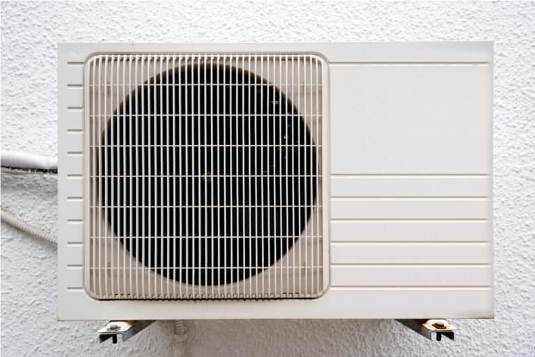 white air conditioner hangs on a wall. close up