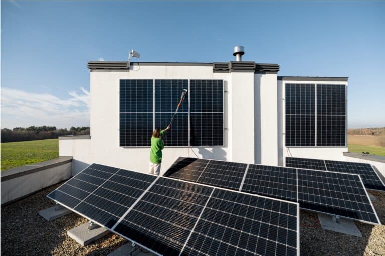 woman washing solar panels on rooftop 2022 12 02 23 57 39 utc
