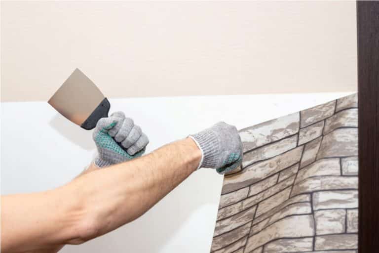 man hand tear off old light wallpaper from wall pr 2023 11 27 05 28 23 utc